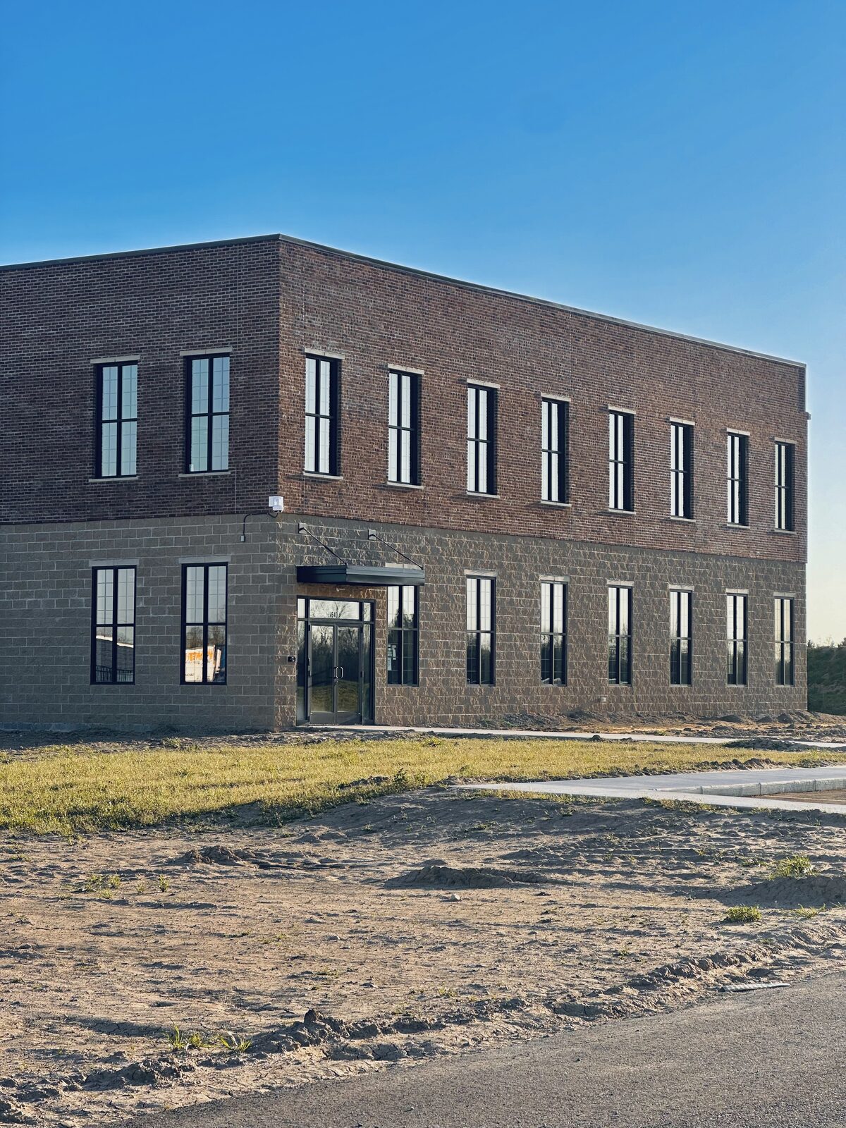 Commercial brick building with glass storefront and entry Michigan